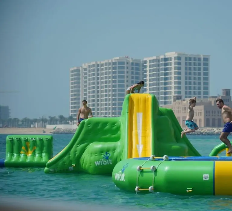 מתקנים מתנפחים ירוקים וצהובים בים